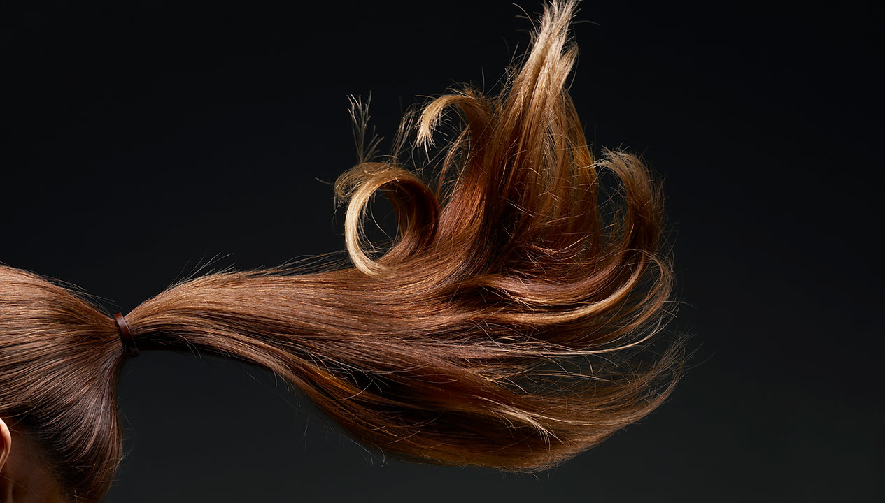 Stylish brown hair in motion, showing colour and condition