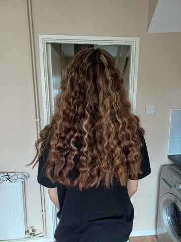Long curly brown hair, finished style from behind