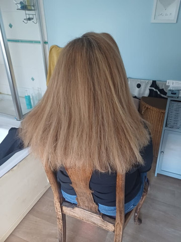 Long straight blonde hair, finished style from behind